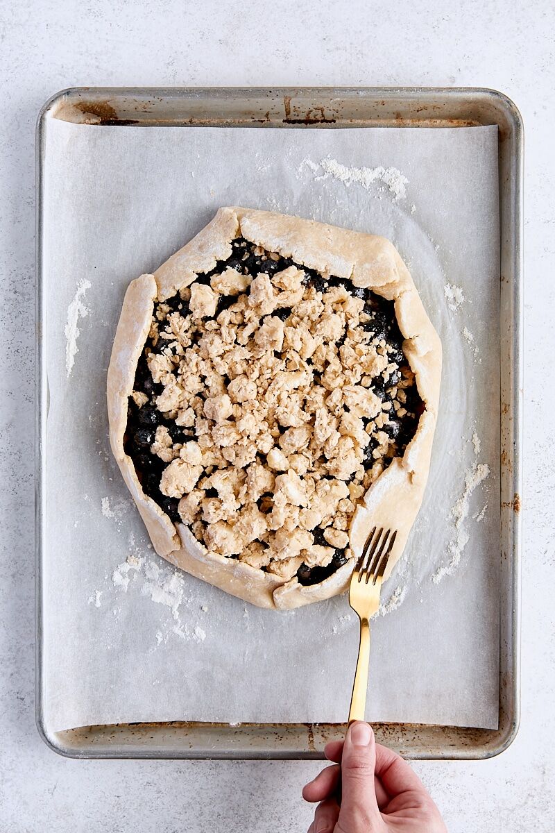 Galette dough folded up around blueberry filling