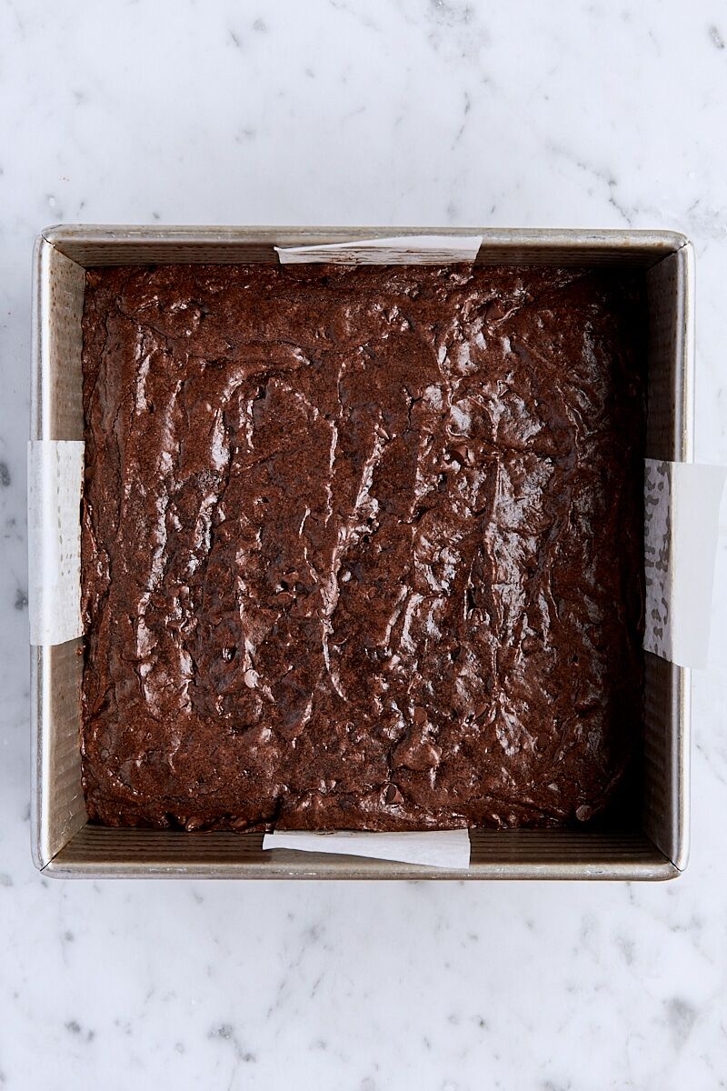 Baked brown butter brownies in parchment-lined square pan