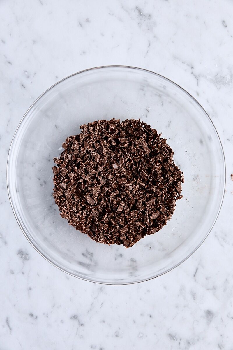 Finely chopped semisweet chocolate in glass bowl