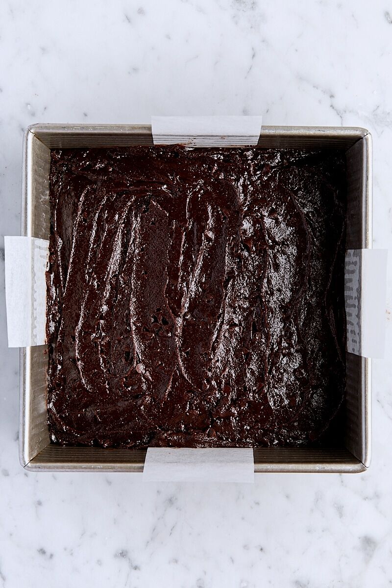 Brown butter brownie batter in parchment-lined square pan