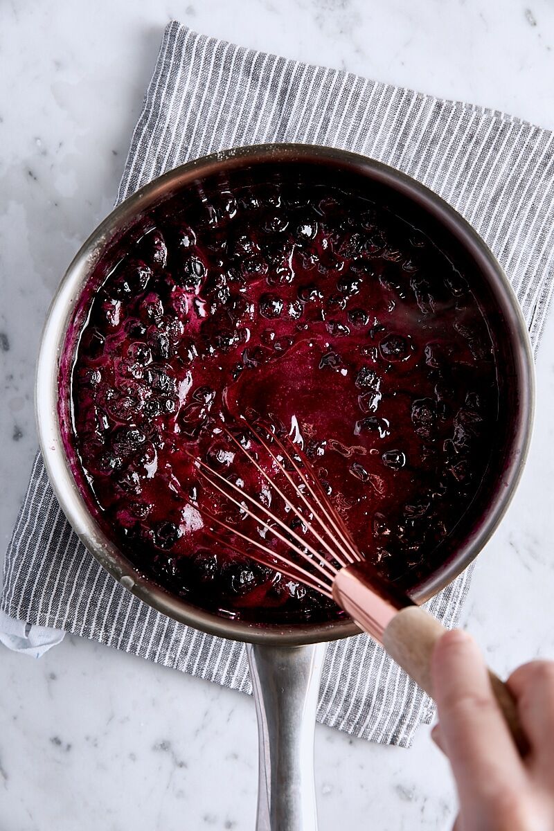 Cornstarch mixture whisked into blueberry filling in saucepan