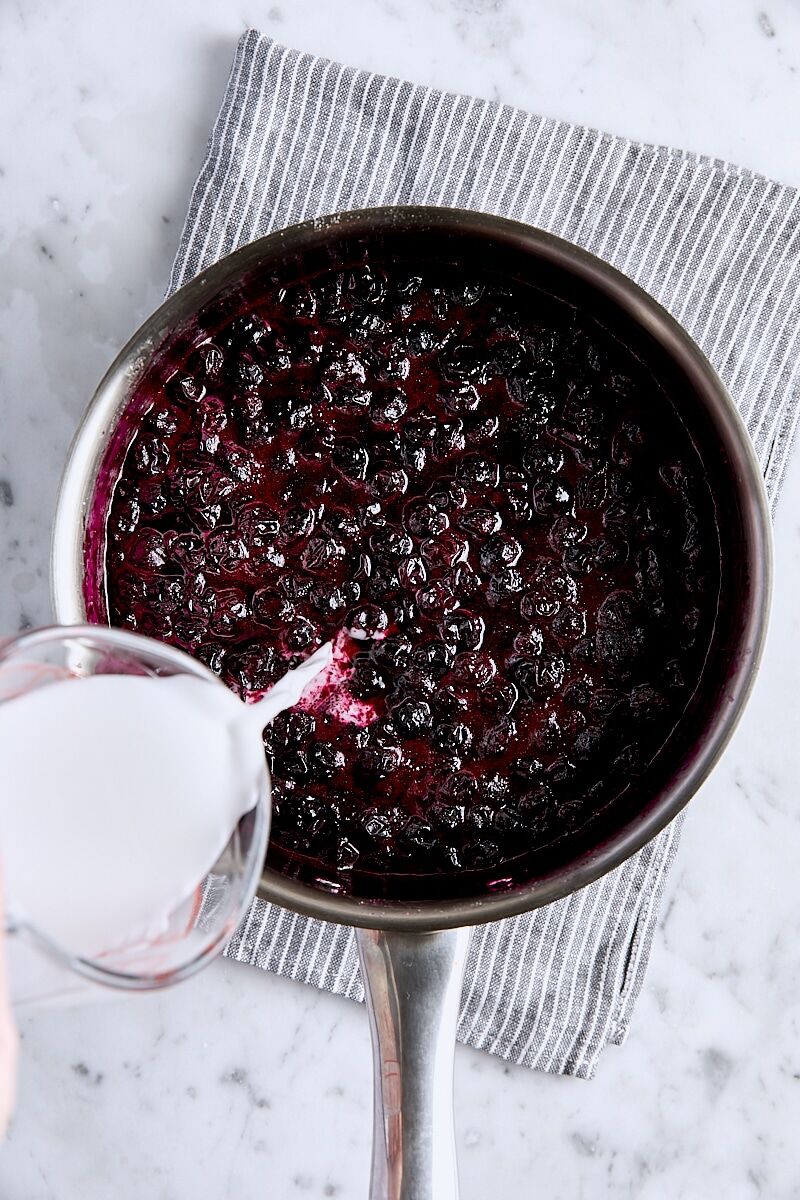 Cornstarch mixture added to blueberry filling in saucepan