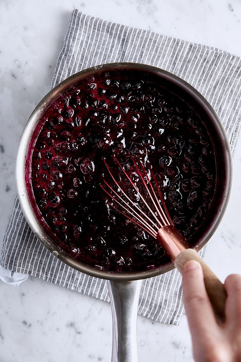 Jammy blueberry pie filling whisked in saucepan