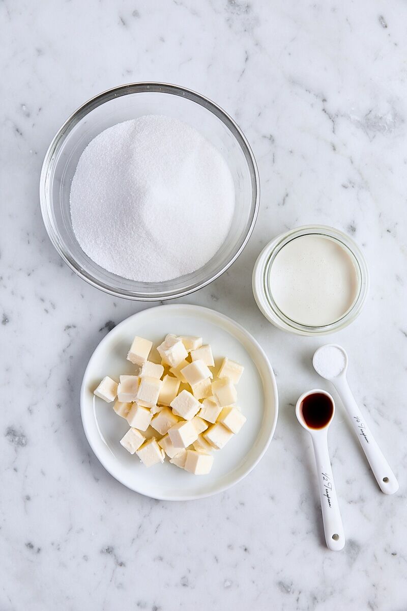 Ingredients for caramel sauce on white marble background