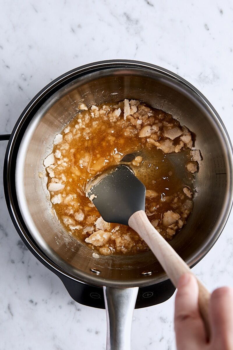 Granulated sugar melting and caramelizing in light-colored saucepan
