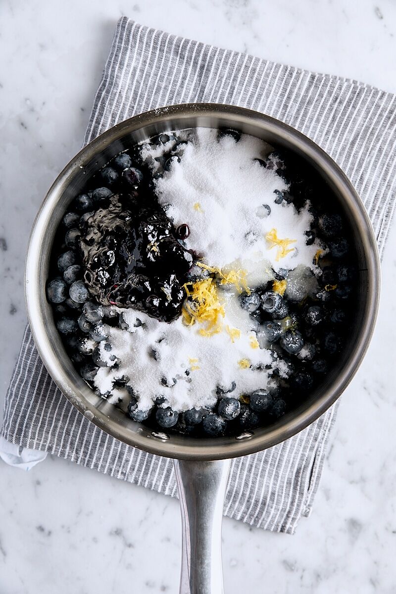 Fresh blueberries, sugar, salt, blueberry preserves, lemon zest, and lemon juice in saucepan