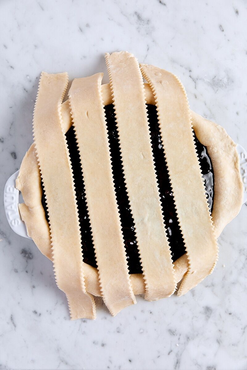Lattice strips over blueberry pie filling in pie pan