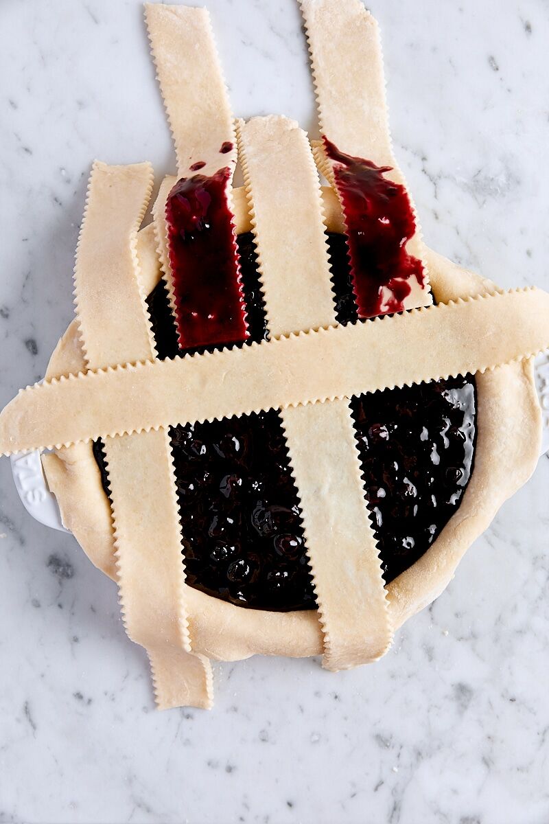 Lattice strips folded back over pie filling