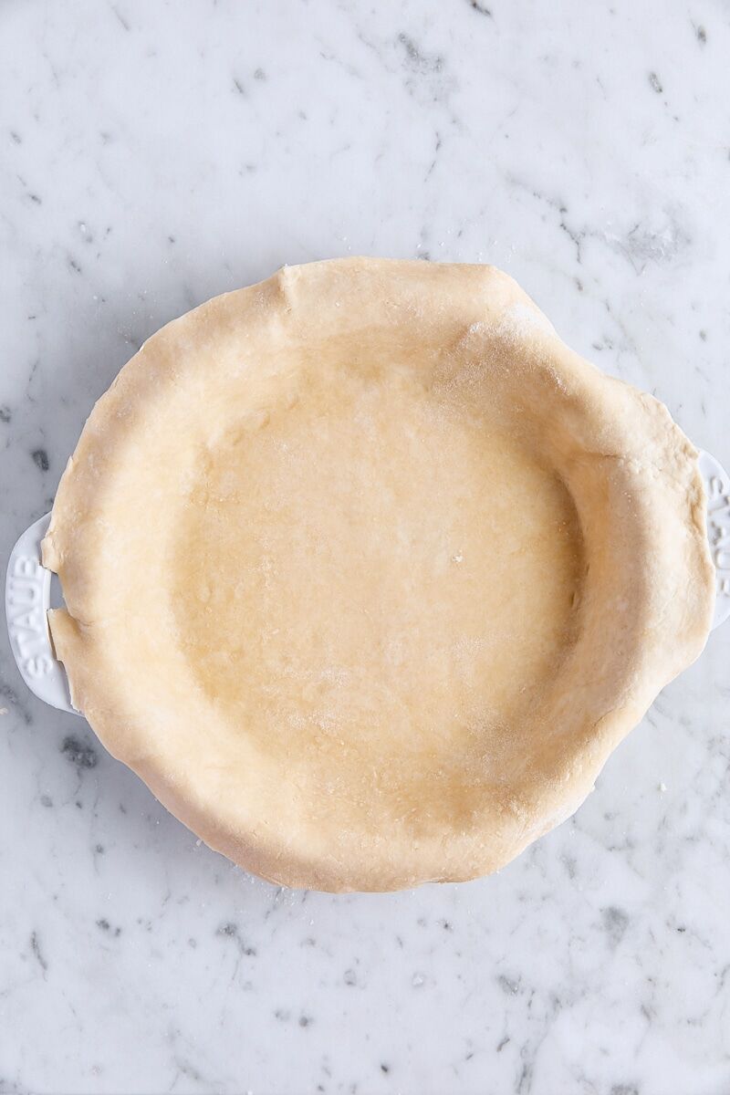 Dough trimmed to 1-inch overhang in pie pan