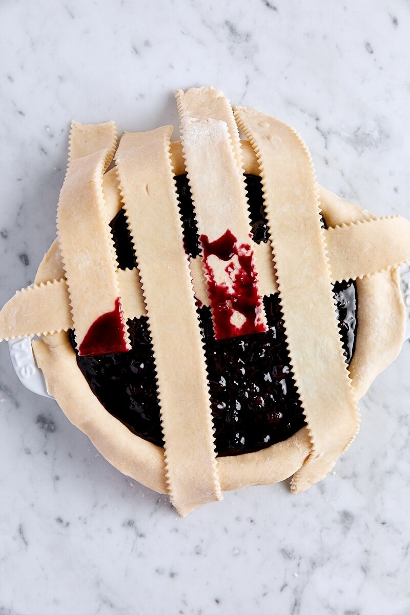 Weaving lattice strips over blueberry filling