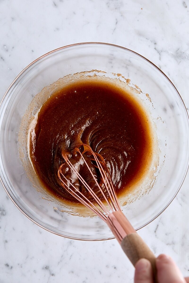 Wet ingredients whisked together in glass bowl