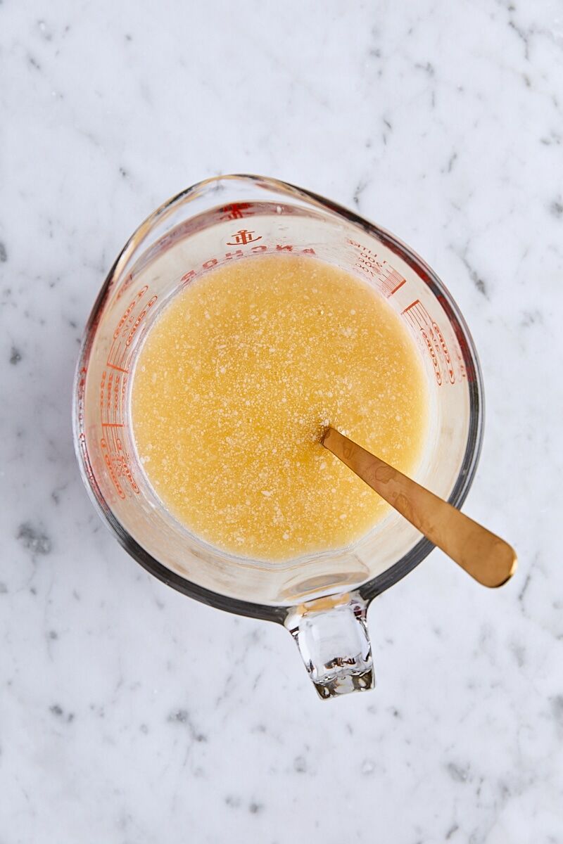 Wet ingredients whisked together in glass measuring cup