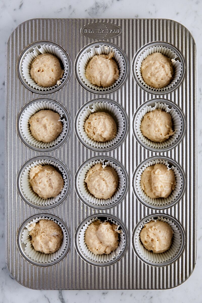Coffee cake muffin batter scooped into muffin tin