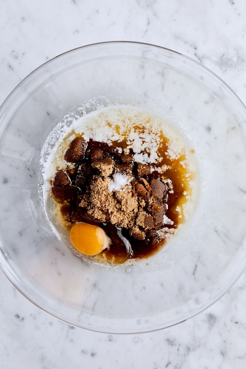 Melted butter, brown sugar, egg, vanilla, cinnamon, and salt in glass bowl