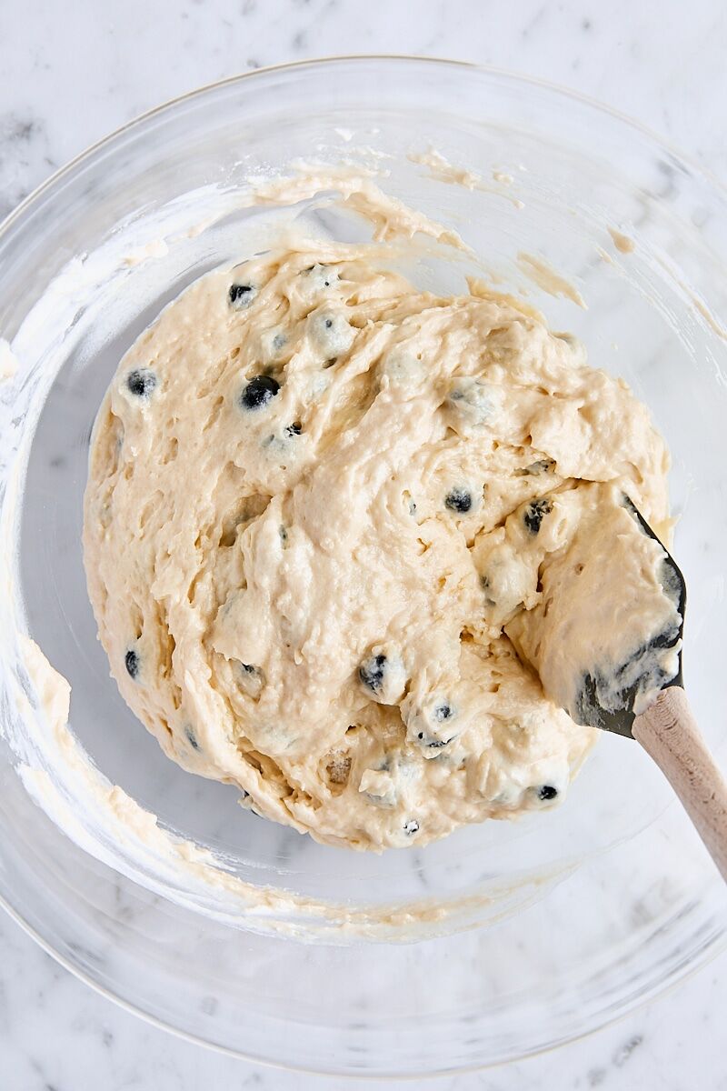 Mixed blueberry muffin batter in glass bowl