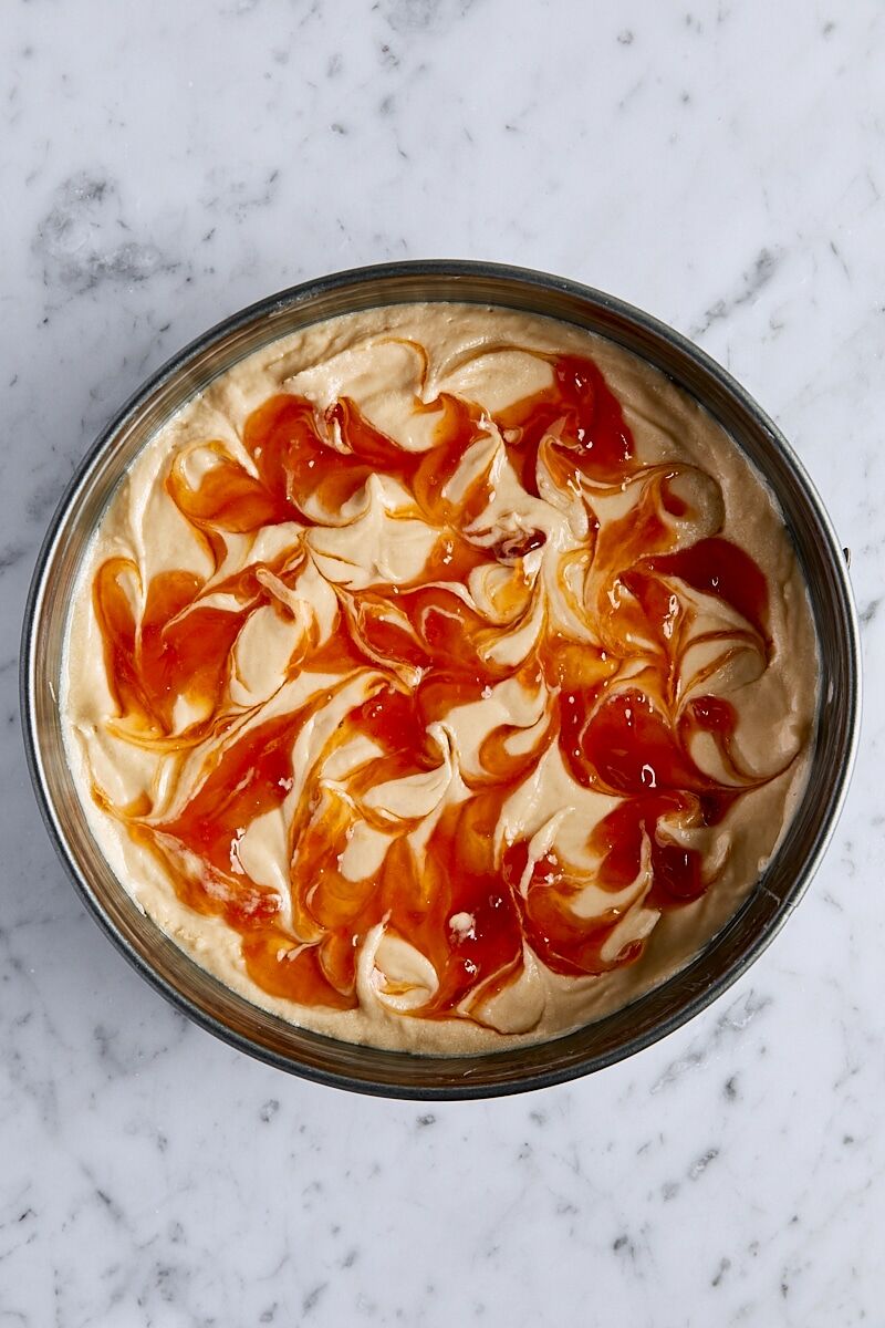 Cake batter with jam swirls in springform pan
