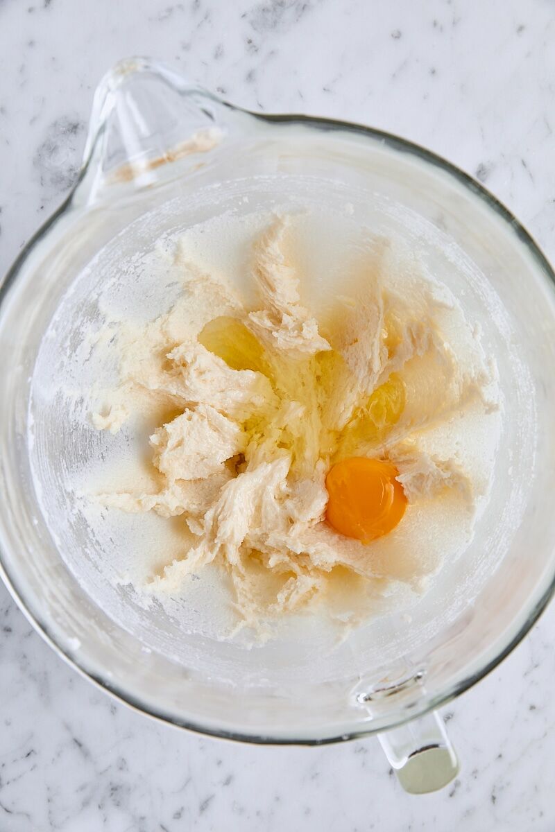 Egg added to batter in glass mixing bowl