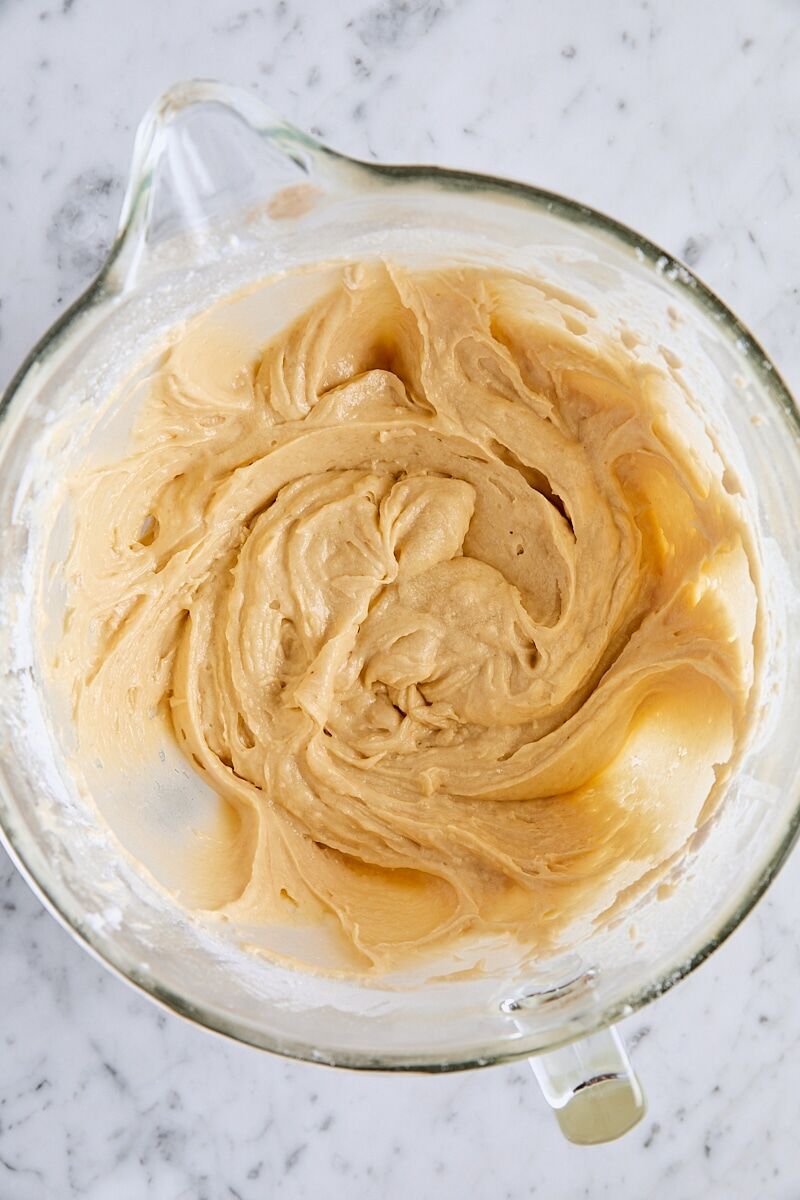 Crumb cake batter in glass mixing bowl with spatula
