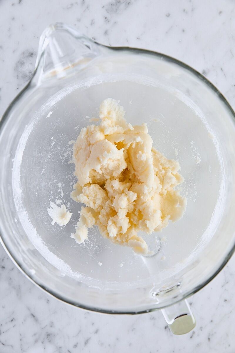 Butter and granulated sugar mixed together in glass mixing bowl