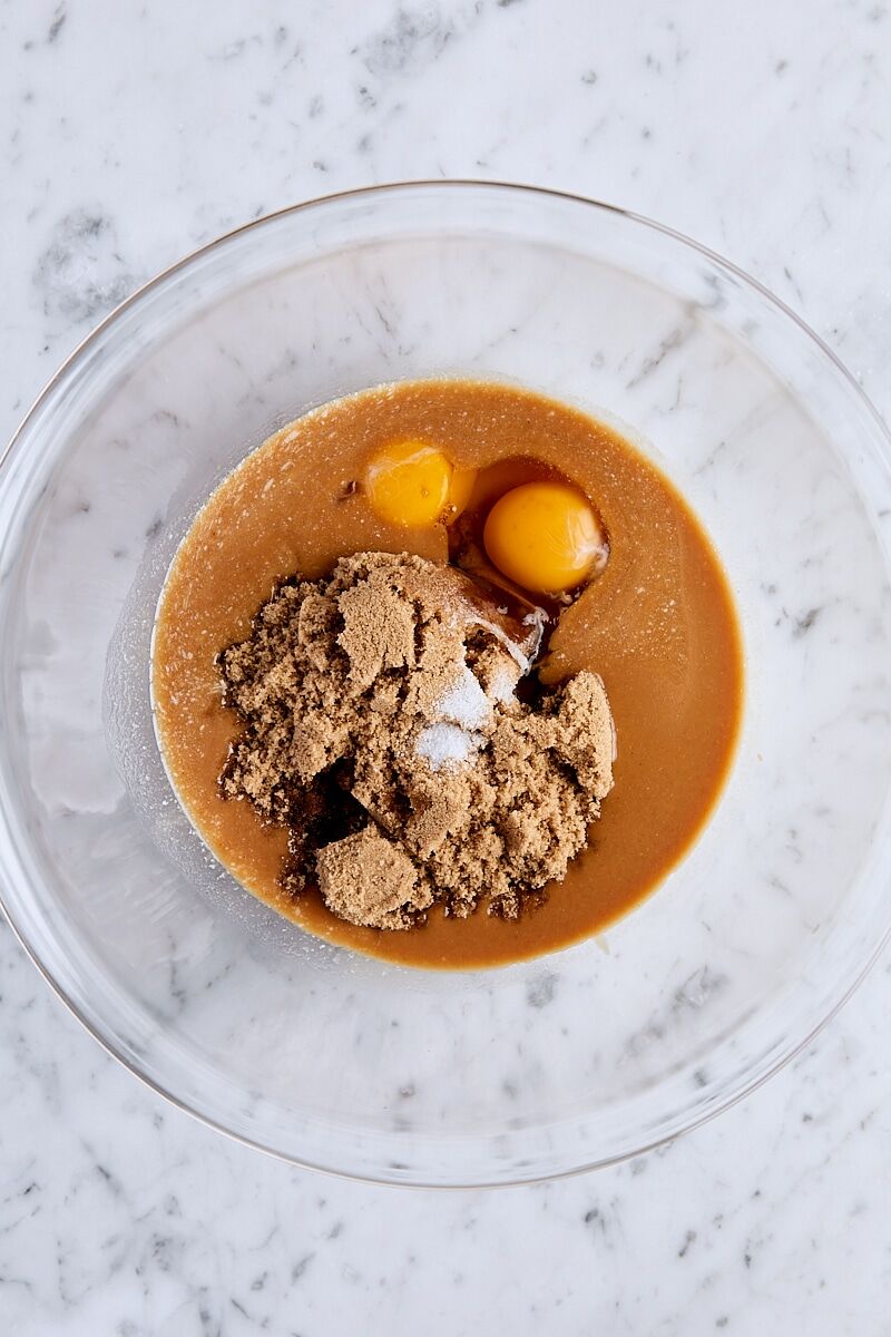 Melted butter, peanut butter, brown sugar, egg, egg yolk, vanilla, and salt in glass bowl