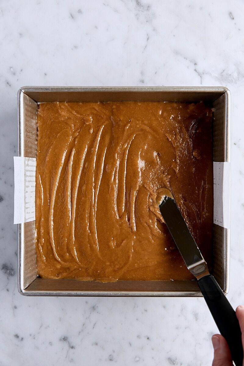 Snickerdoodle blondie batter in parchment-lined square pan