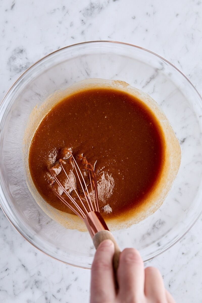Wet ingredients whisked together in glass bowl