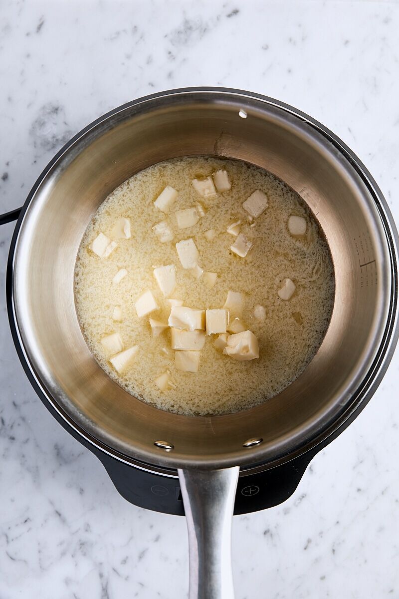 Cubed butter melting in saucepan