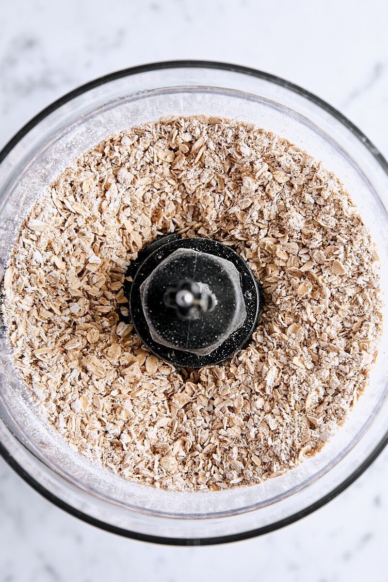 Coarsely ground rolled oats in the bowl of a food processor