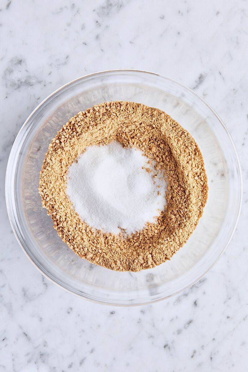 Graham cracker crumbs, granulated sugar, and salt in glass bowl