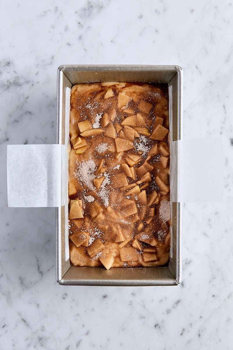 Cinnamon sugar sprinkled over the top of unbaked apple fritter bread