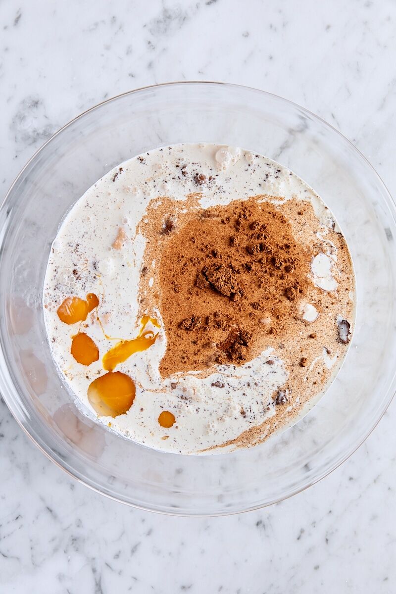 Pumpkin puree, brown sugar, spices, salt, whole milk, heavy cream, egg yolks, eggs, and vanilla in large glass bowl