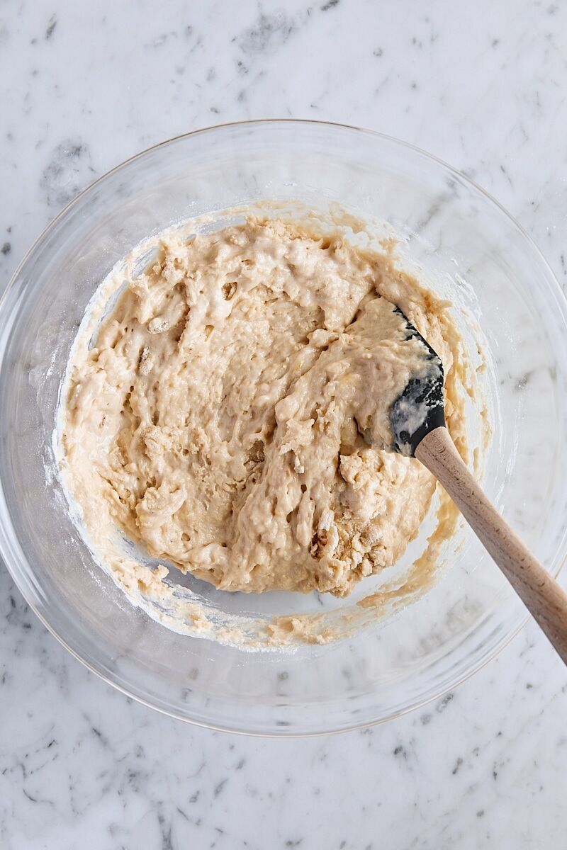 Folding banana mixture into flour mixture with a rubber spatula
