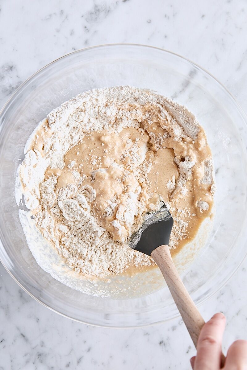 Folding apple cider mixture into flour mixture with a rubber spatula