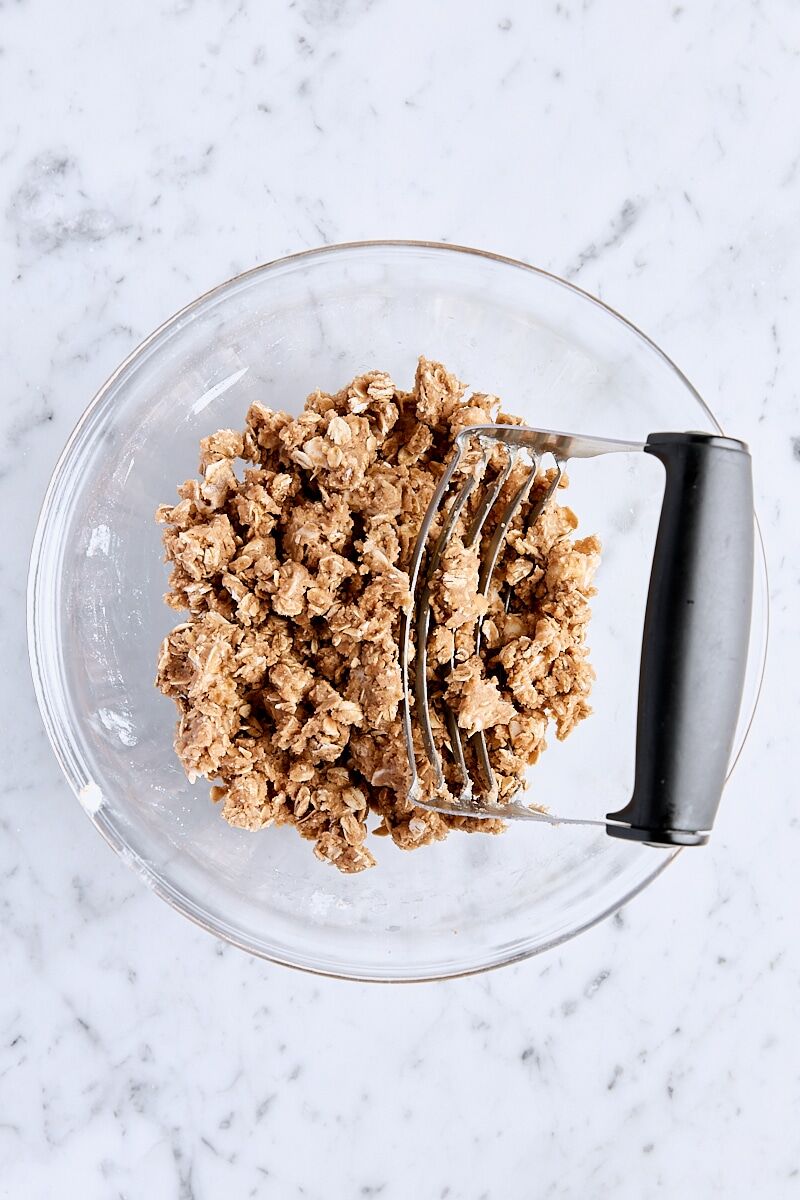 Cubed butter cut into oatmeal mixture with a pastry cutter