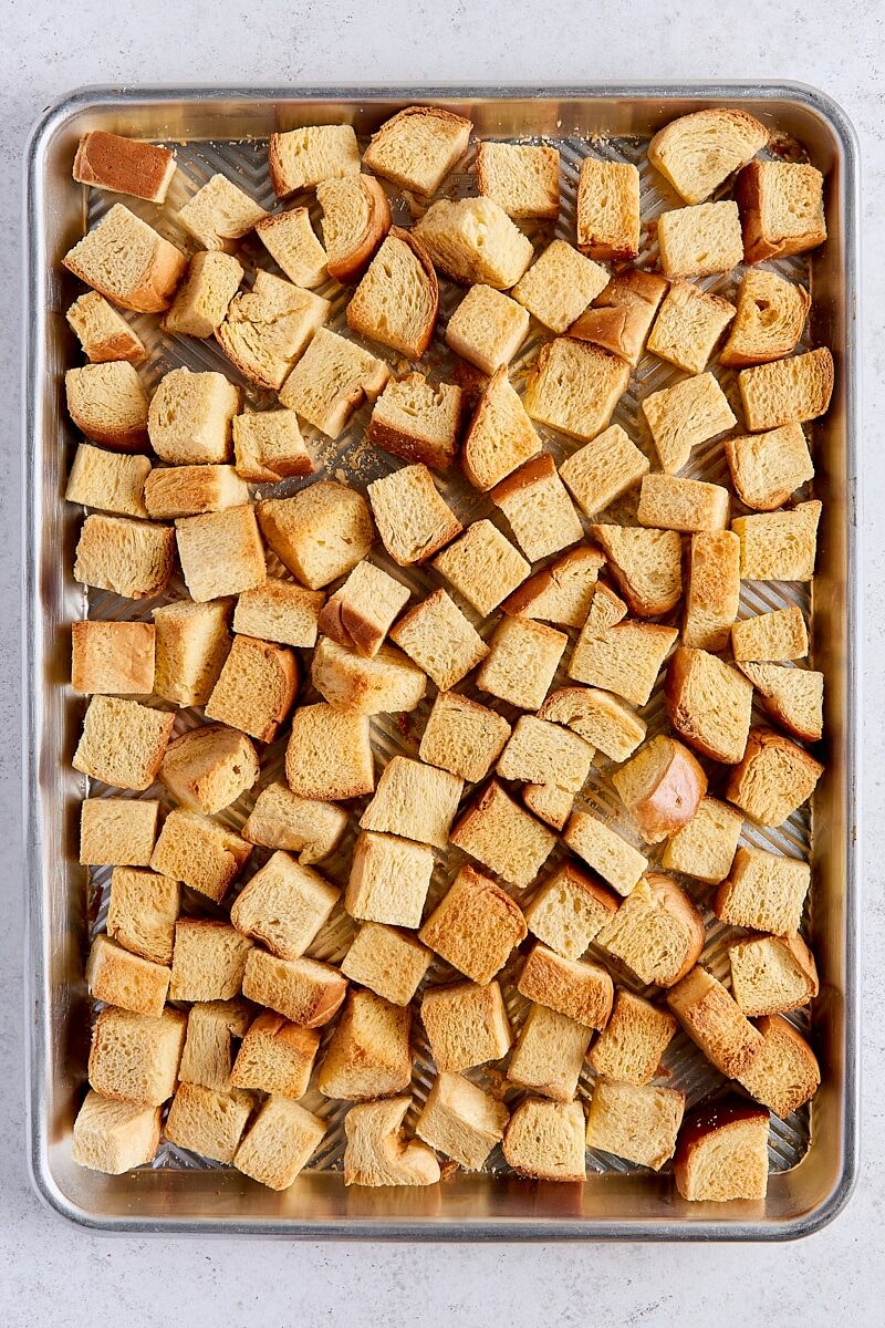Oven-dried brioche bread on rimmed baking sheet