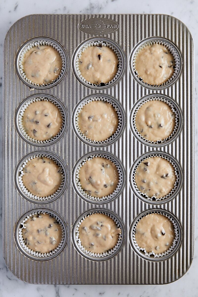 Banana bread muffin batter scooped into muffin tin