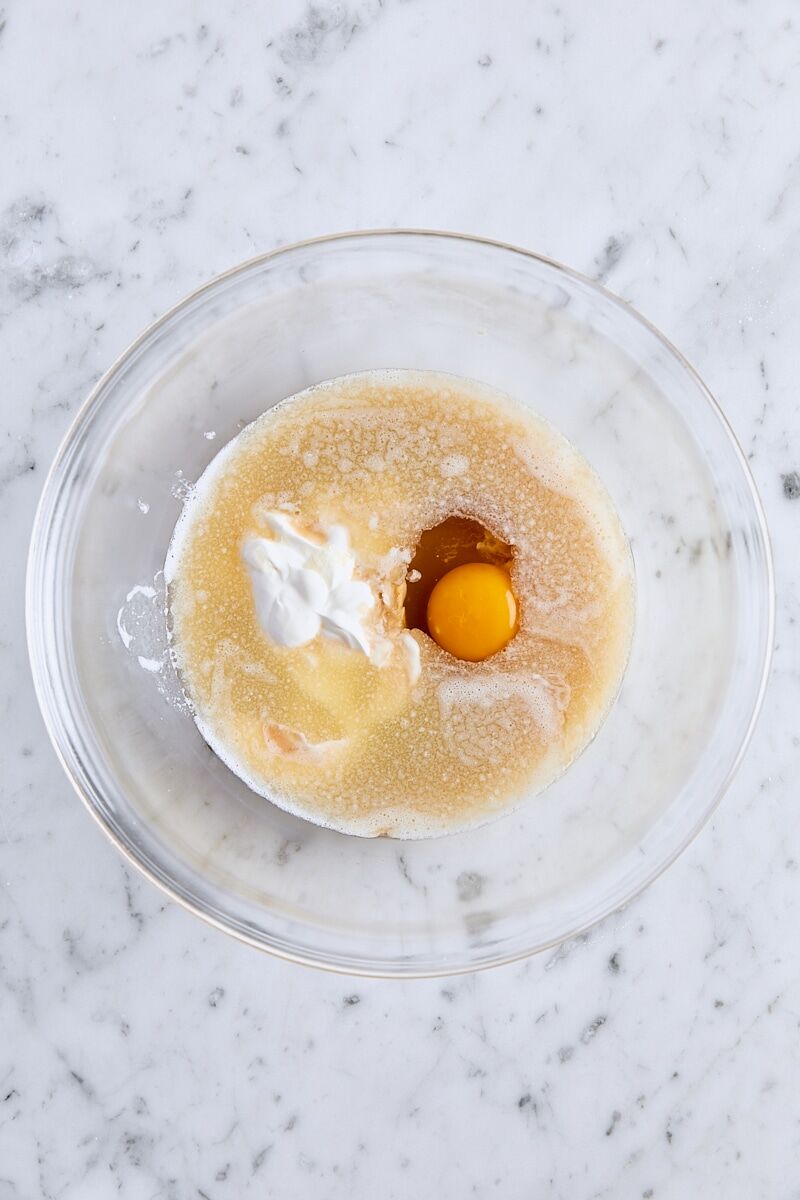 Melted butter, oil, apple cider, sour cream, egg, and vanilla extract in glass bowl