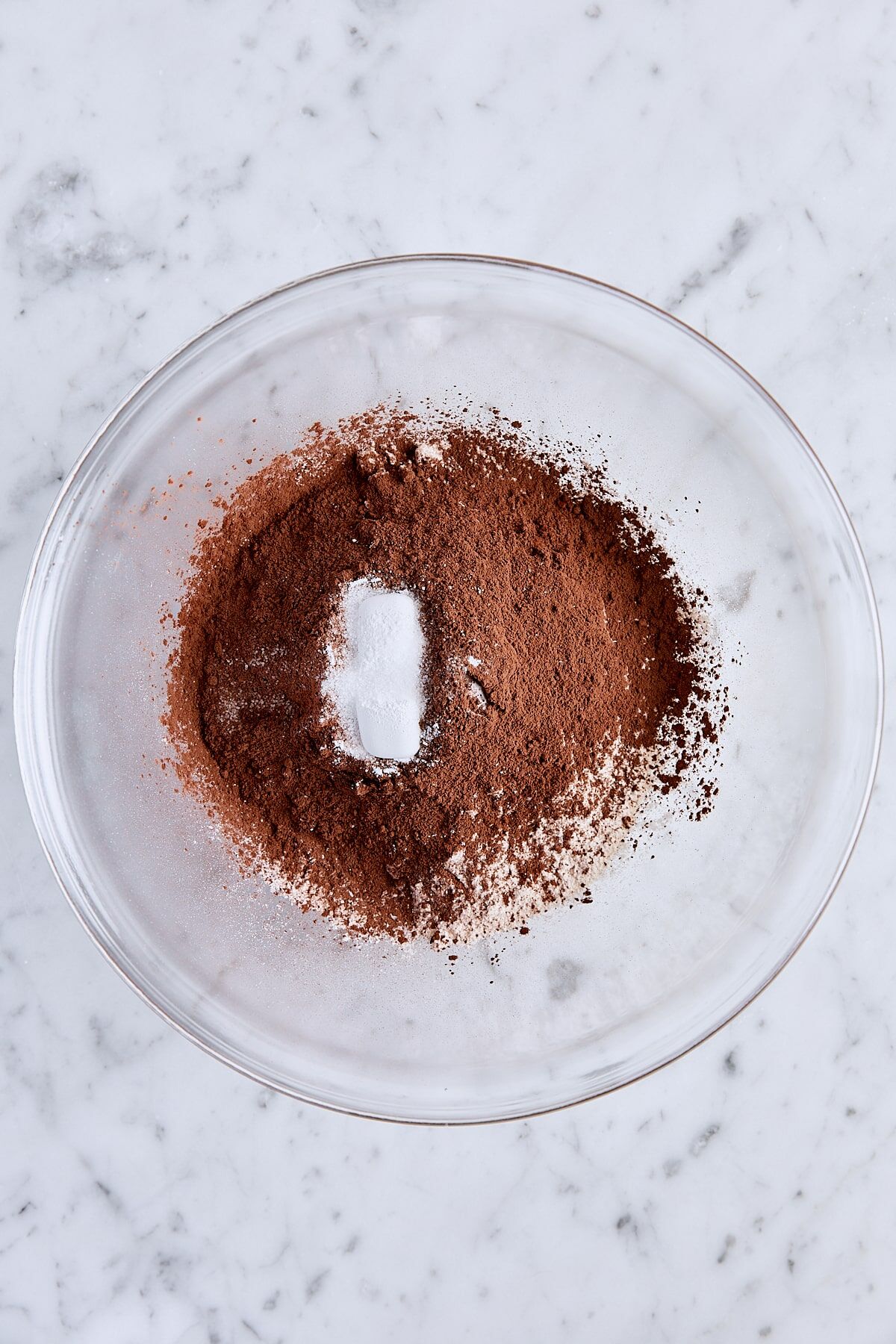 All-purpose flour, sifted Dutch process cocoa, baking powder, and salt in glass bowl