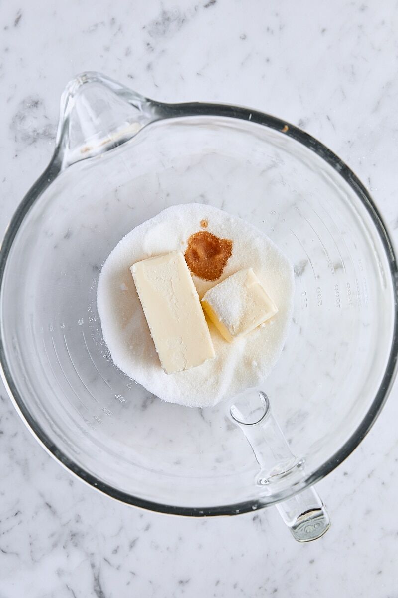 Softened butter, granulated sugar, vanilla, almond extract, and salt in glass mixer bowl