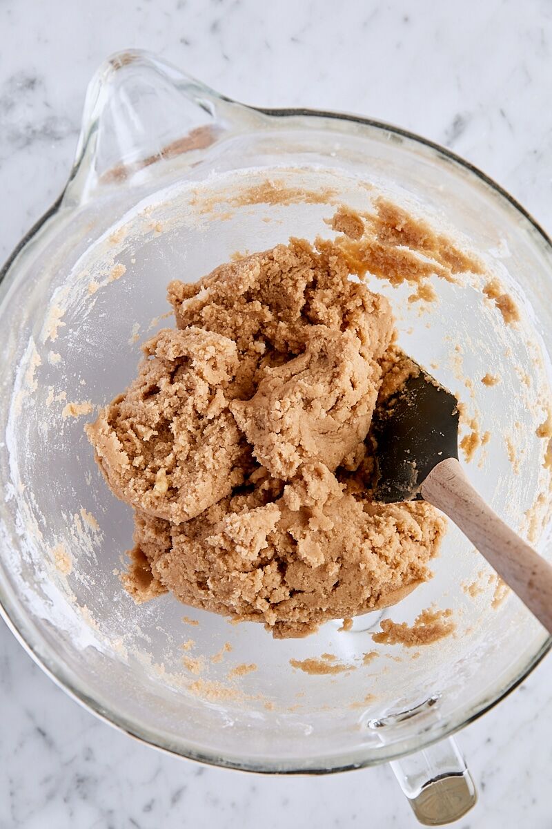 Snickerdoodle cookie dough in glass bowl with spatula