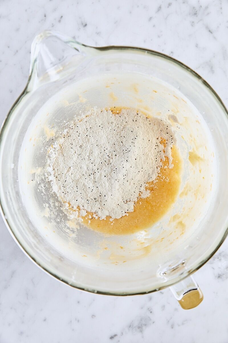 Dry ingredients added to batter in glass mixer bowl