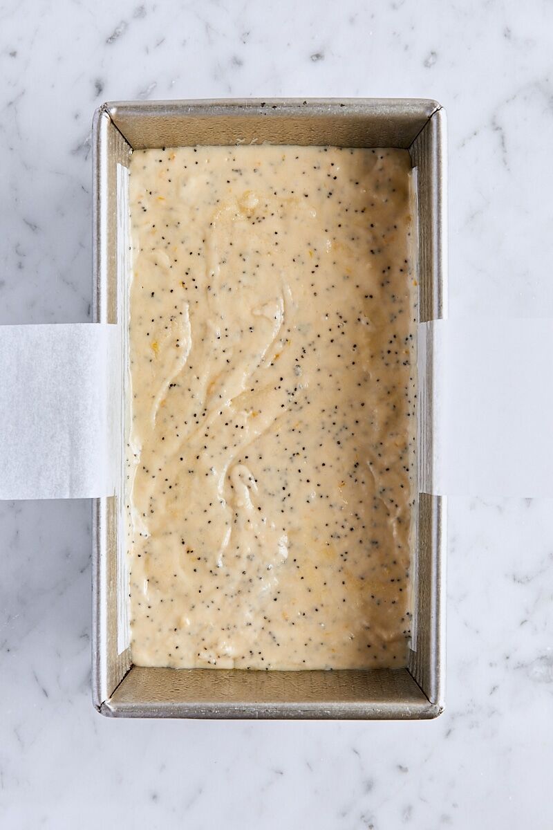 Lemon poppy seed batter in parchment-lined loaf pan