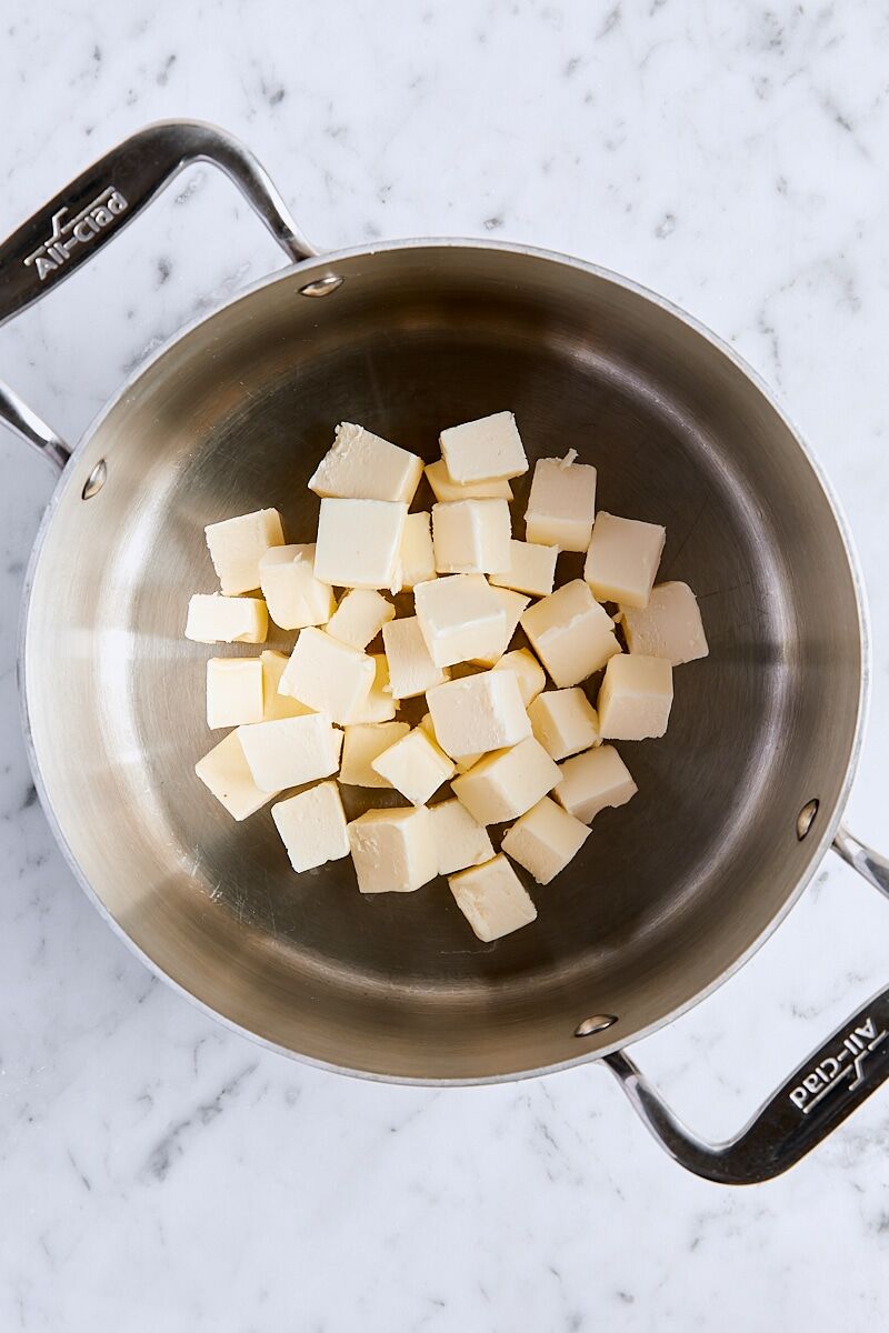 Cubed unsalted butter in saucepan