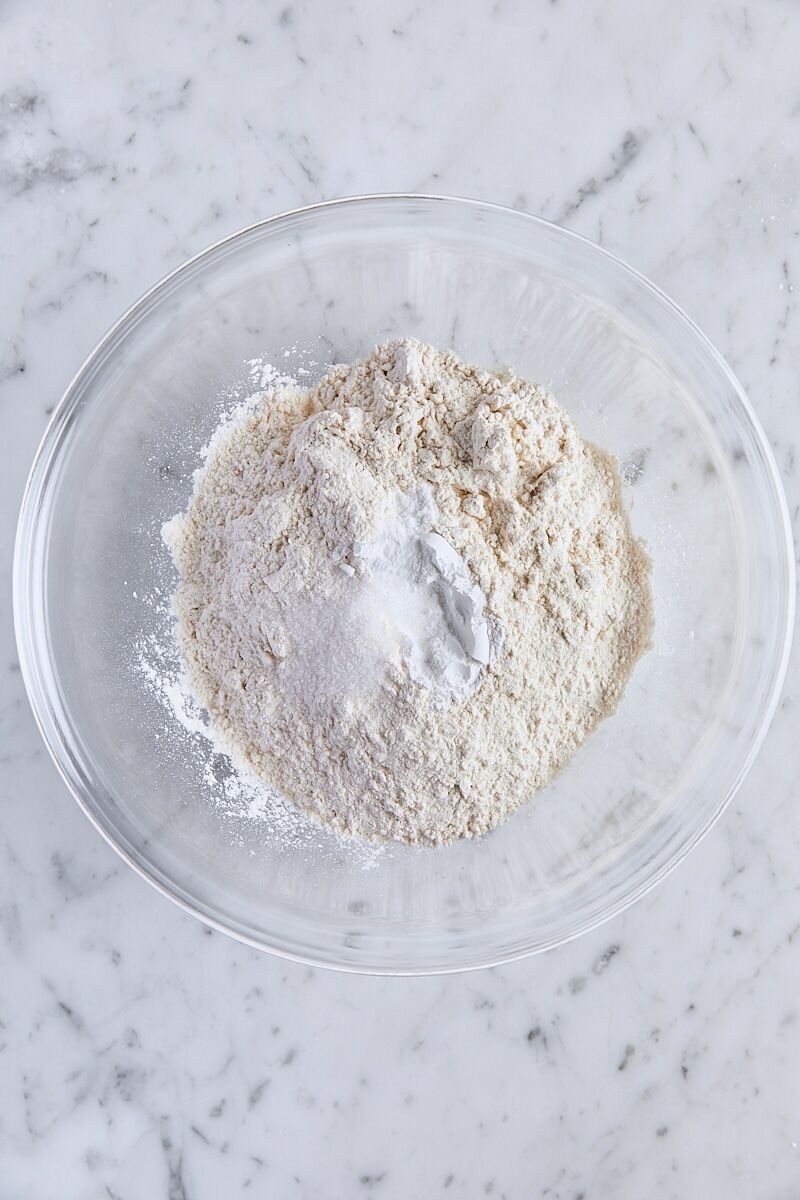 All-purpose flour, baking powder, baking soda, and salt in medium glass bowl