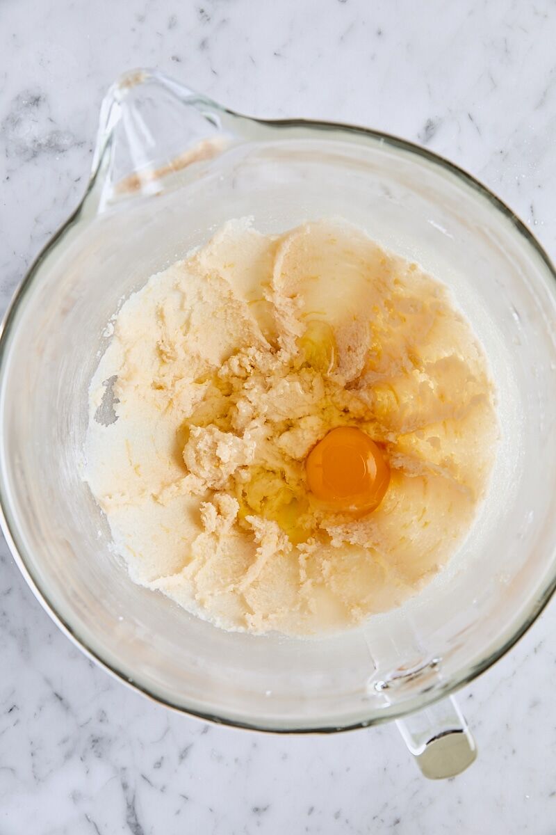 Egg added to batter in glass mixer bowl