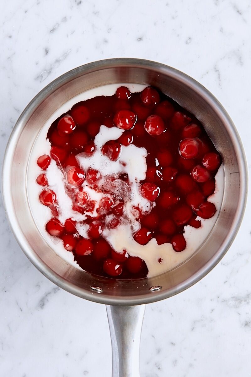 Canned cherry pie filling, cornstarch slurry, lemon juice, almond extract, and salt in saucepan
