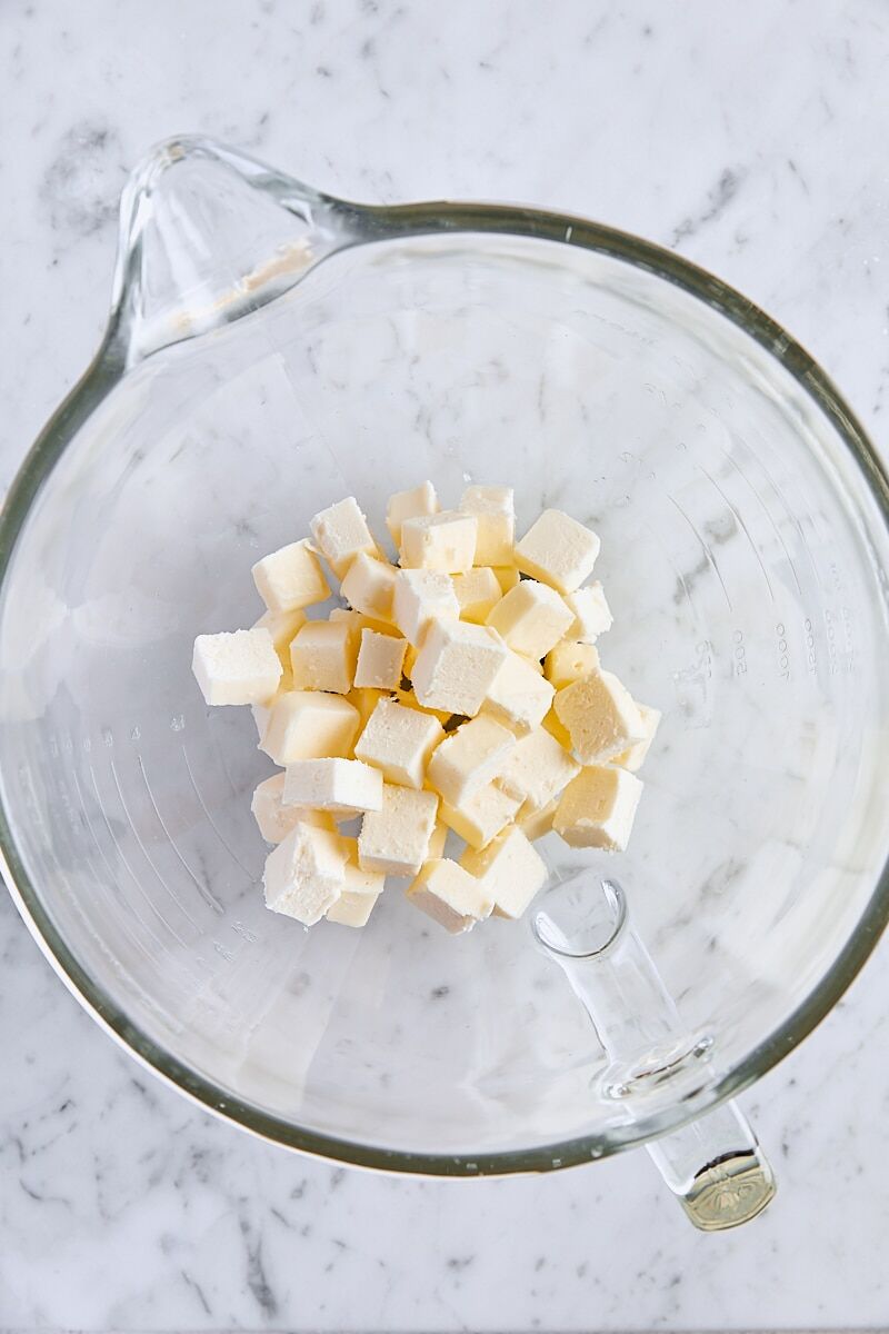 Cubed unsalted butter in glass mixer bowl