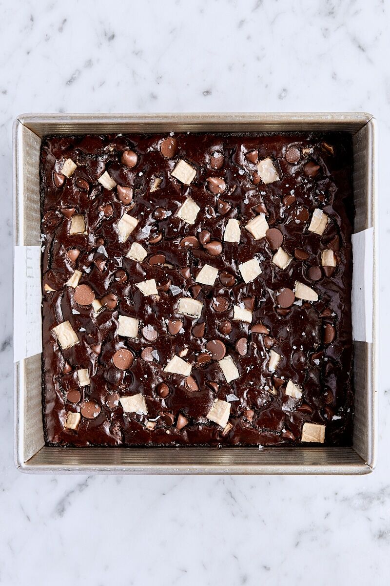 Baked triple chocolate brownies in parchment-lined pan