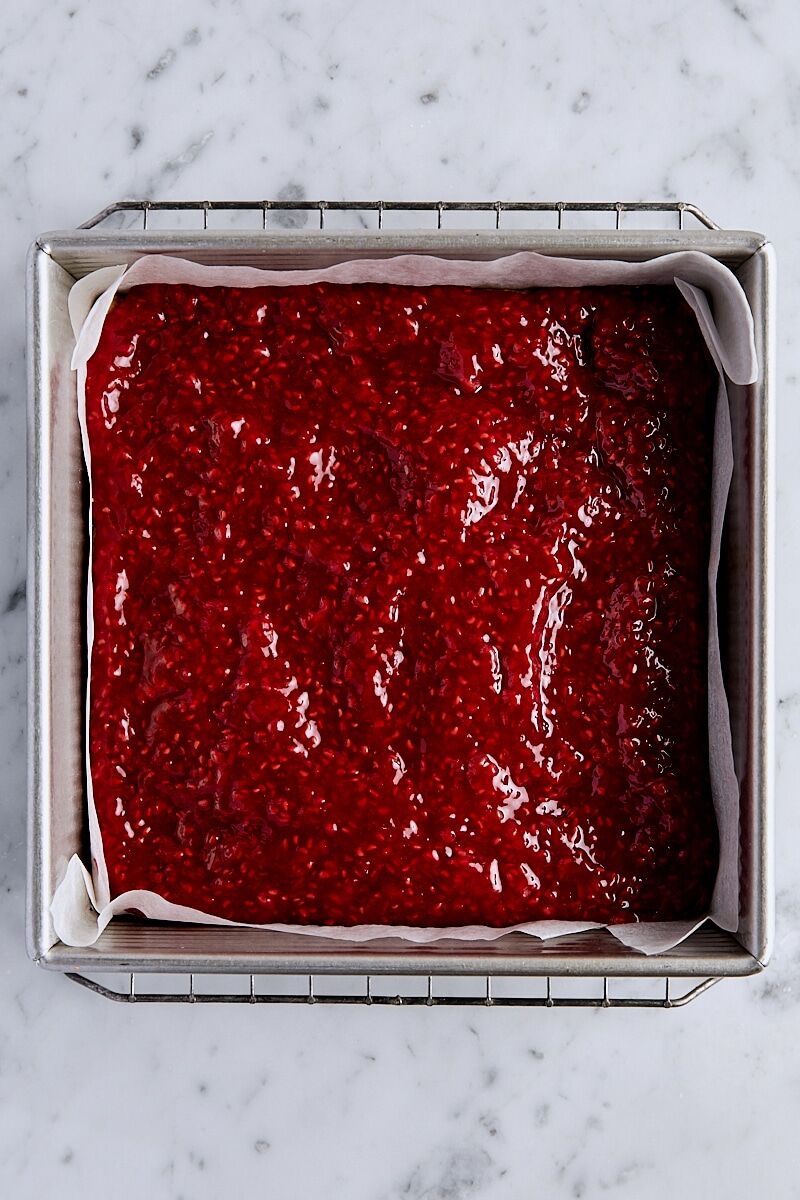 Raspberry filling spread over par-baked crust