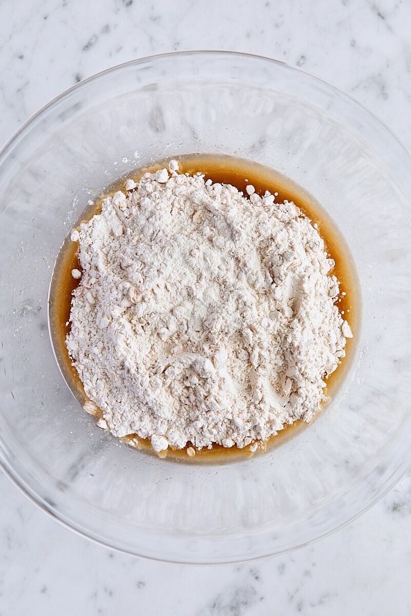 Flour mixture added to melted butter mixture in large glass bowl